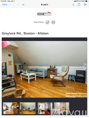 A living room with a grey couch, a white coffee table, and a wooden chair.