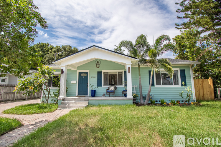 A small house with a blue door and a porch.