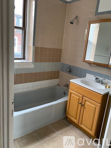 A bathroom with a white sink and a bathtub.