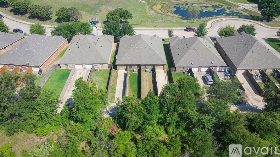 A bird's eye view of a residential area with houses and trees.