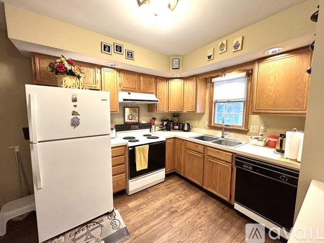 A kitchen with wooden cabinets and a white fridge.