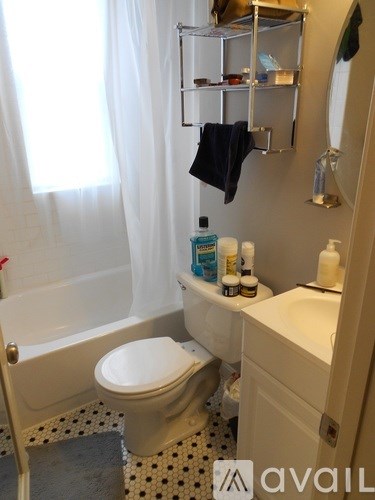 A white toilet sits in a bathroom next to a sink.