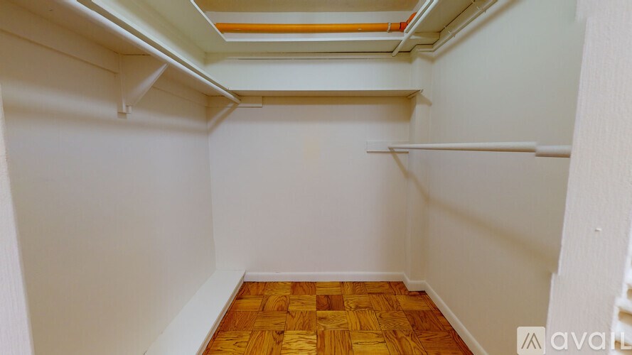 A room with wooden flooring and white walls.