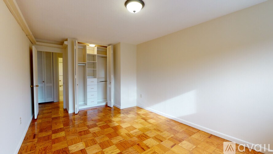 A room with a wooden floor and white walls.