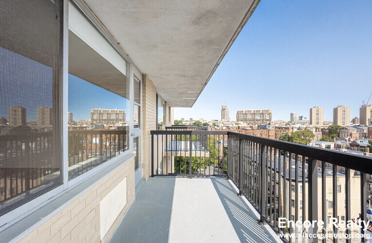 A balcony with a view of a city skyline.