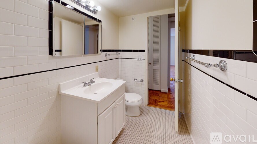 A bathroom with a white sink and toilet.