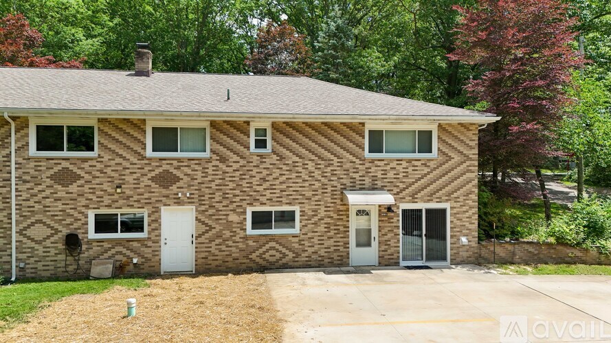 A house with a brown brick exterior and a grey roof.