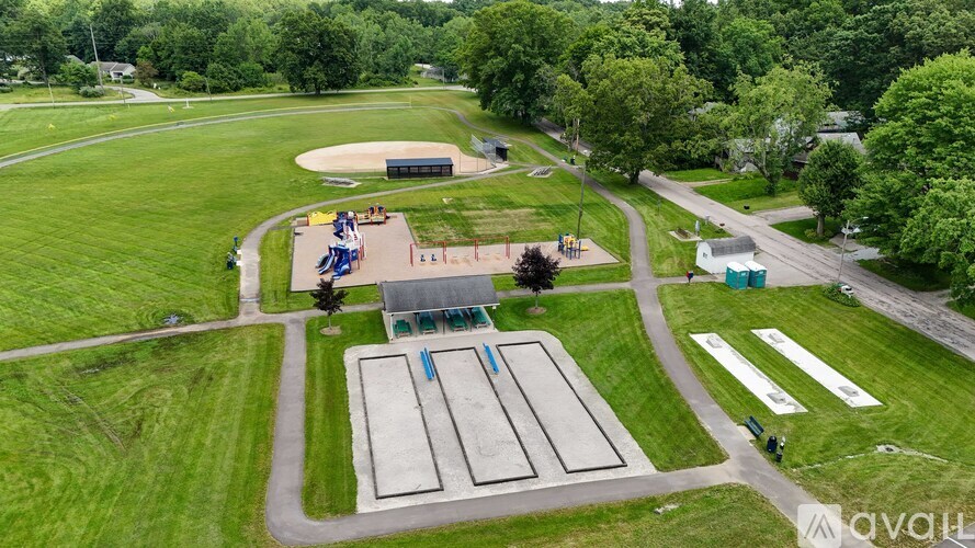 An aerial view of a park with a playground and a basketball court.