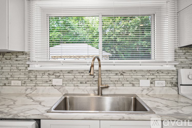 A bathroom with a sink, mirror, and toilet.