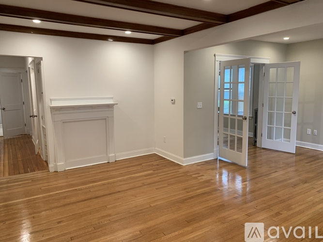 A room with wooden floors and a fireplace.