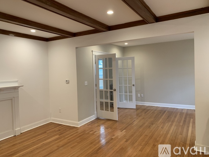 A room with wooden floors and a white door.