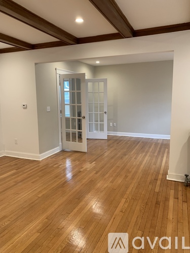A room with wooden floors and a white door.