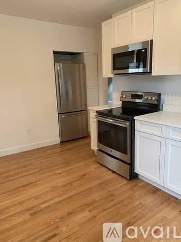 A kitchen with a stainless steel refrigerator, oven, and microwave.