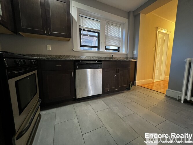 A kitchen with a stove top oven and a dishwasher.