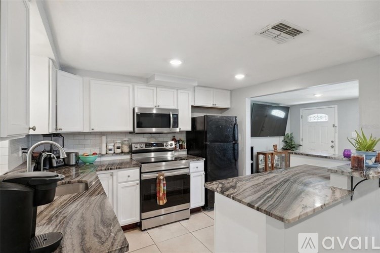 A kitchen with granite countertops and stainless steel appliances.