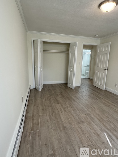 A room with a light grey floor and white walls.