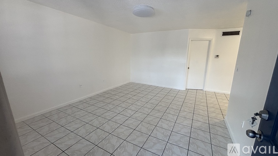A room with white walls and a tiled floor.