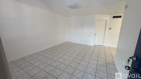 A room with white walls and a tiled floor.