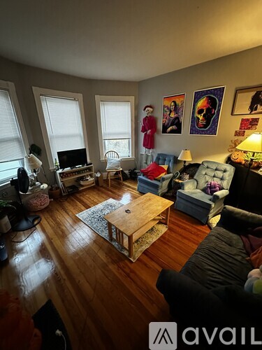 A living room with a couch, chair, and television.