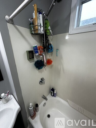 A bathroom with a white tub and a white sink.