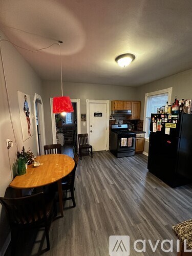 A kitchen with a table and chairs in the middle of the room.