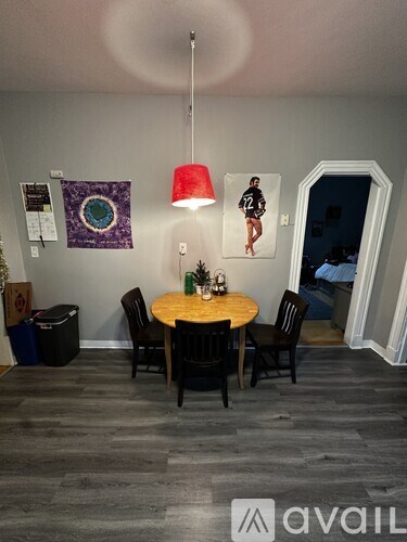 A dining room with a round table and chairs.