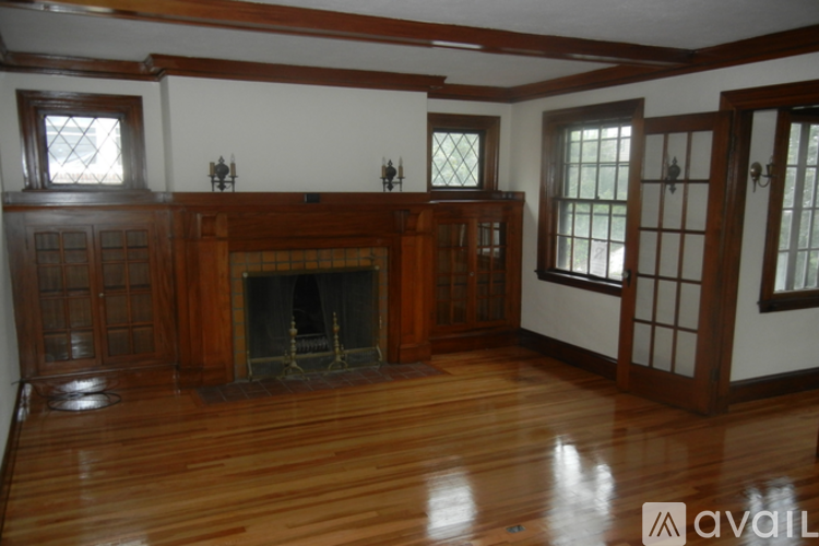 A room with a fireplace and wood floors.