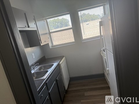 A small kitchen with a sink and a window.