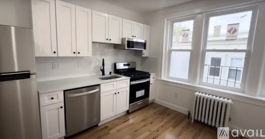 A kitchen with white cabinets and stainless steel appliances.