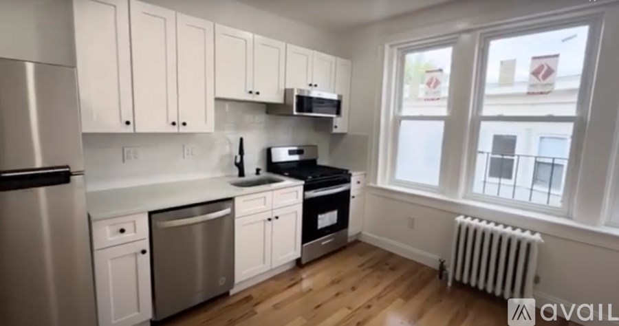 A kitchen with white cabinets and stainless steel appliances.