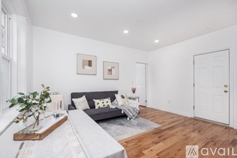A living room with a grey couch and a wooden coffee table.