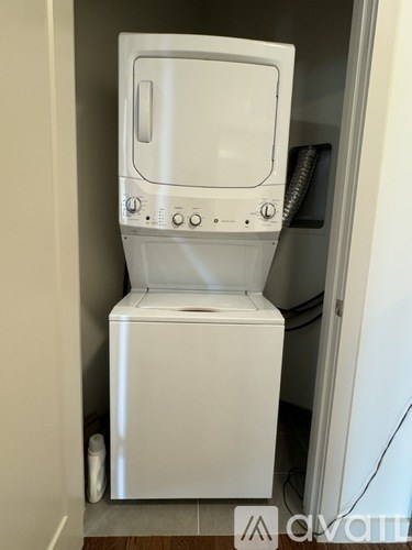 A white washing machine in a small room.