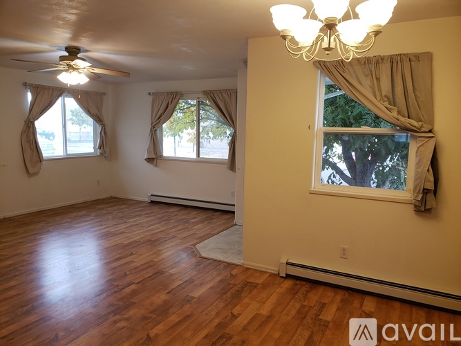 A room with wooden floors and a chandelier.