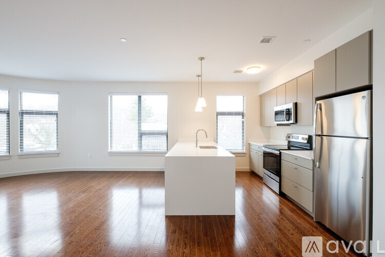 A kitchen with wooden floors and stainless steel appliances.