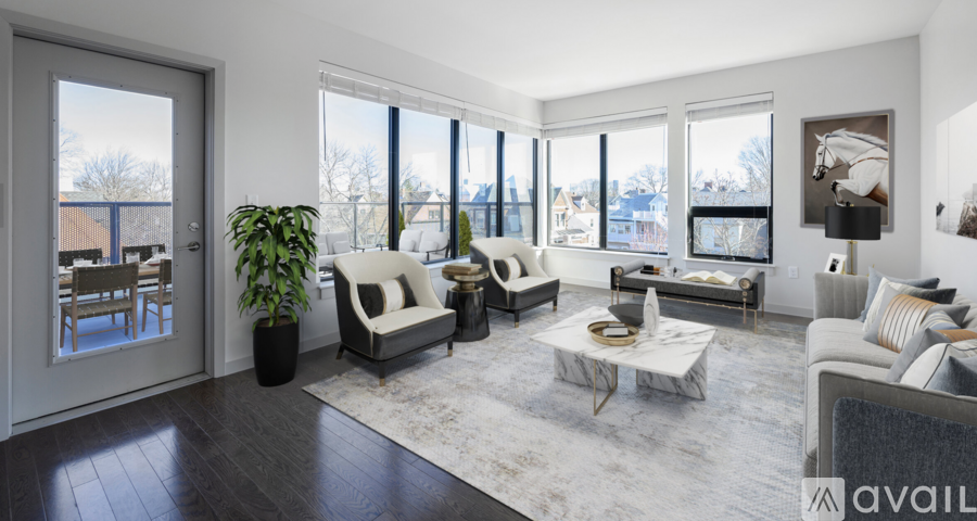 A living room with a large window and a view of a snowy landscape.