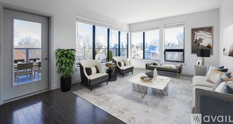 A living room with a large window and a view of a snowy landscape.