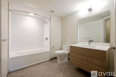 A bathroom with a toilet, sink, and bathtub.