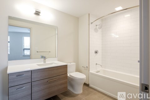 A bathroom with a white sink, toilet, and bathtub.