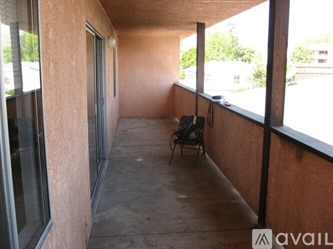 A patio with a chair and a table.