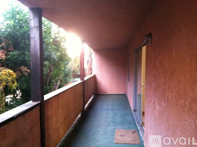 A long hallway with a mat on the floor.