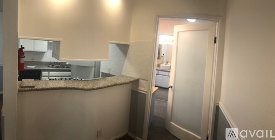 A kitchen area with a counter and a door.