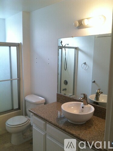 A bathroom with a sink, toilet and shower.
