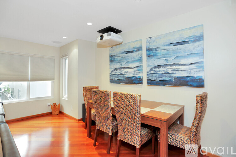A dining room with a table and chairs.
