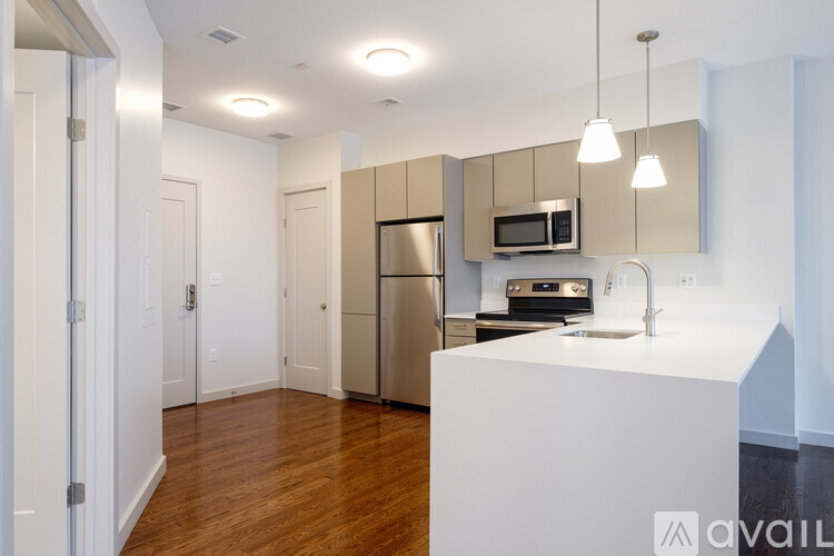 A kitchen with a white island and stainless steel appliances.