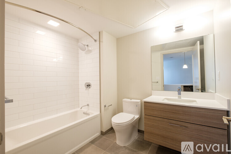A bathroom with a white tub, toilet, and sink.