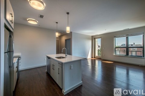 A kitchen with white cabinets and a refrigerator.