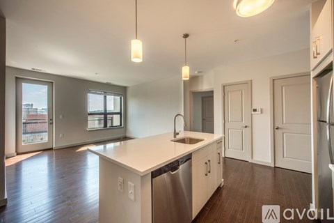 A kitchen with white countertops and stainless steel appliances.