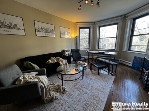 A living room with a couch, chair, and coffee table.