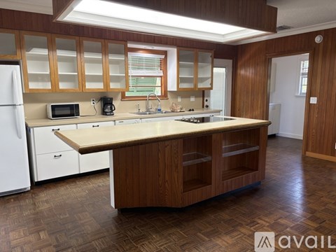 A kitchen with wooden cabinets and a white refrigerator.