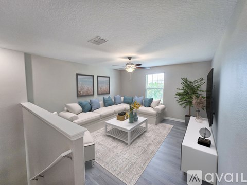 A living room with a white couch and a coffee table.